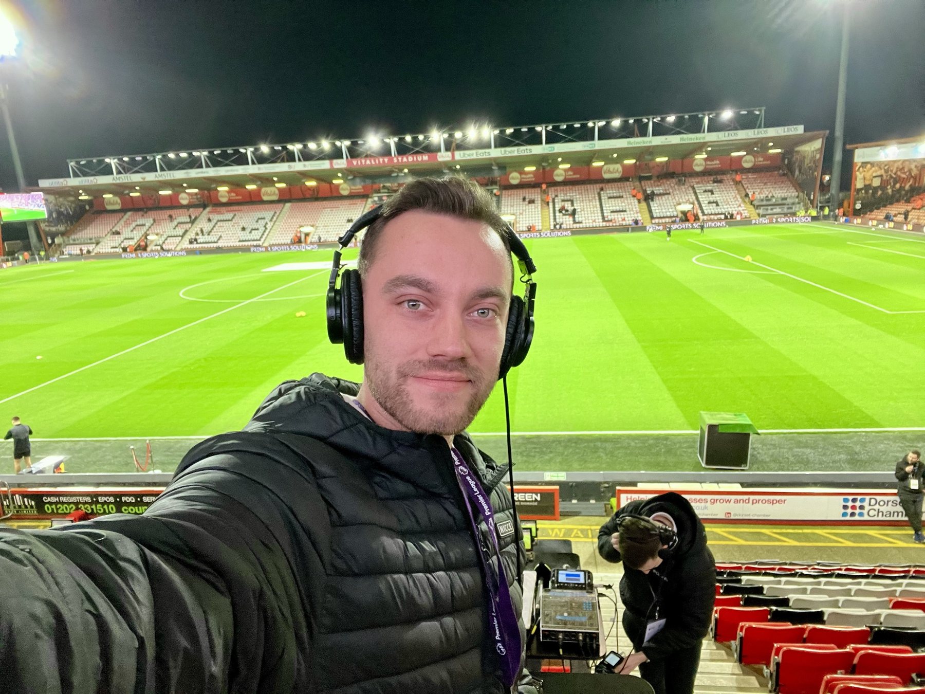 Me at a floodlit Bournemouth football stadium preparing for commentary